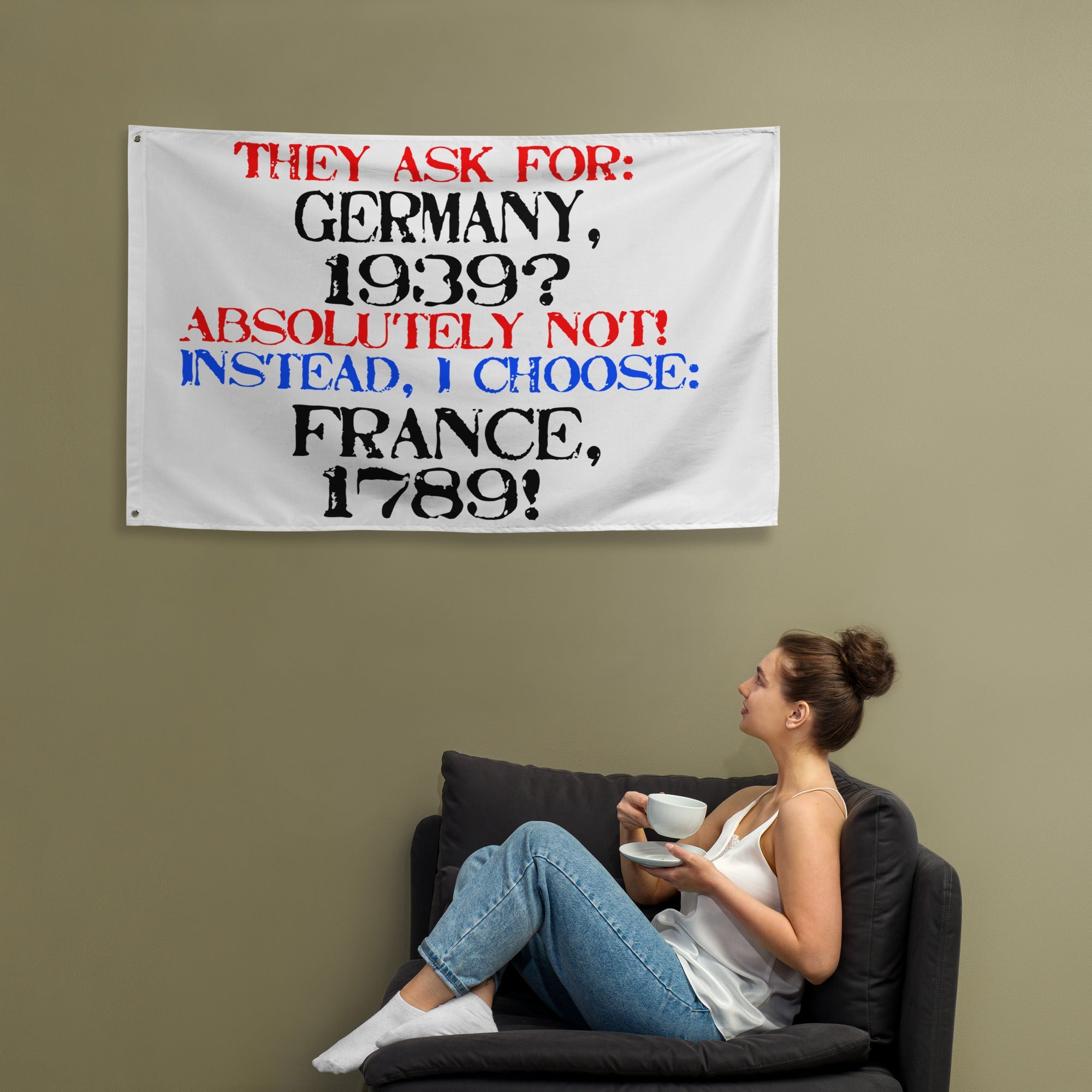 White flag with bold text contrasting Germany 1939 and France 1789, hung on wall.