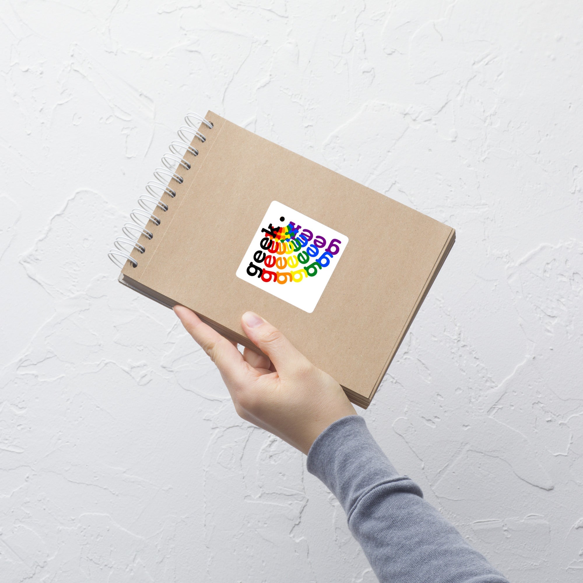 Rainbow geek bubble-free sticker on a notebook, featuring durable, high-opacity vinyl for easy application.