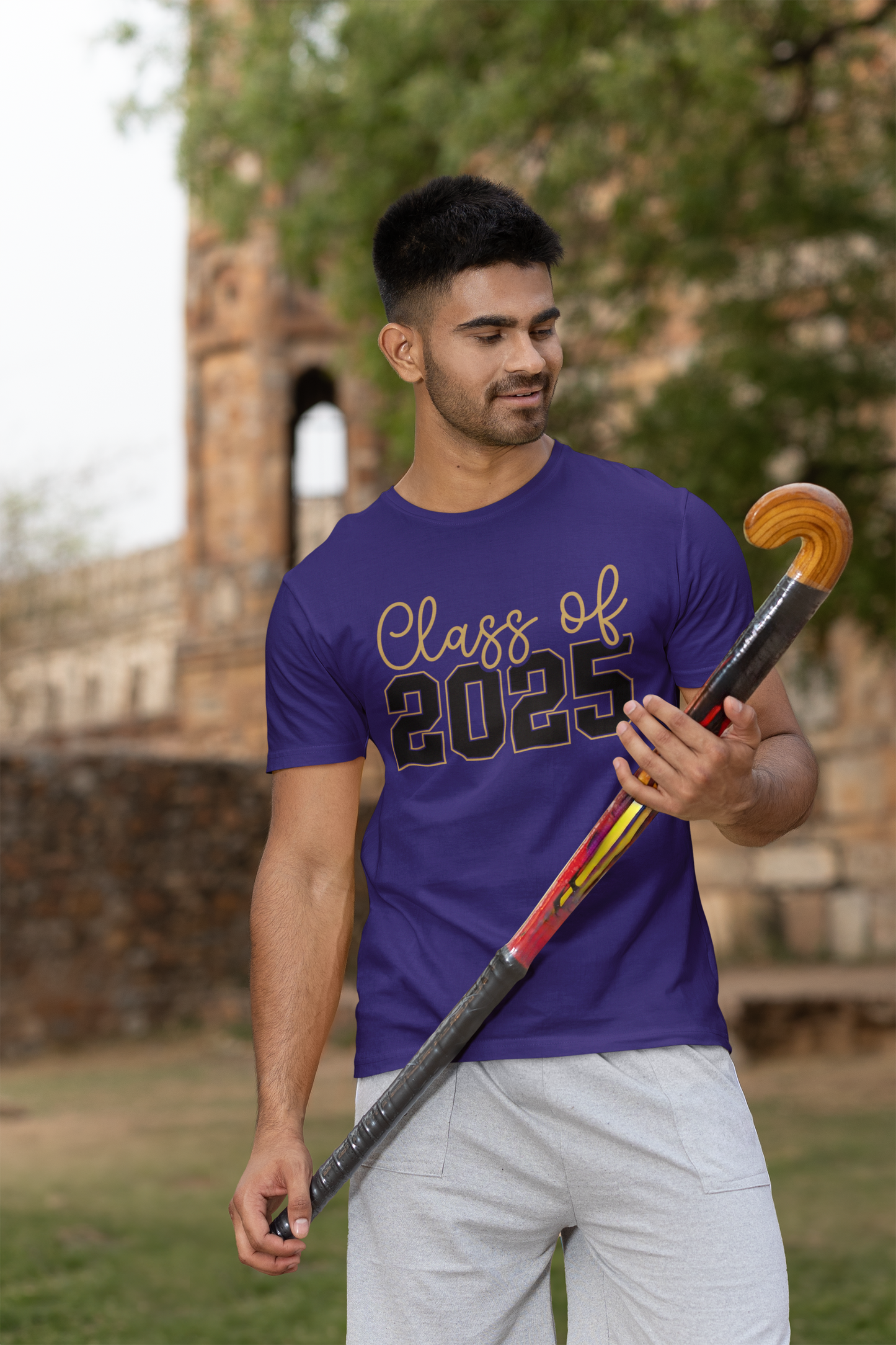 Unisex t-shirt with "Class of 2025" design, worn outdoors.