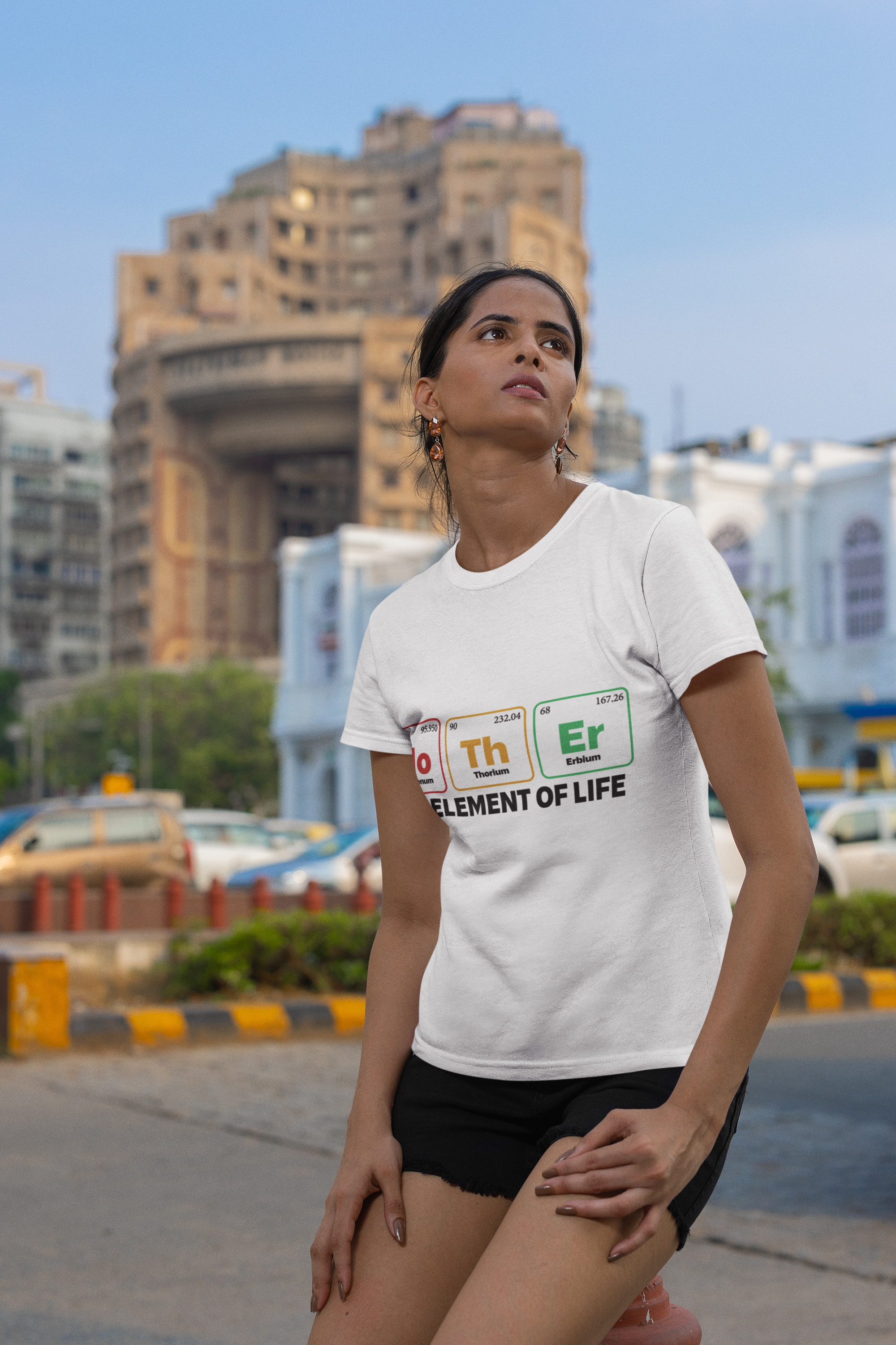 Light unisex t-shirt with "Mother - the Element of Life" design, worn outdoors.
