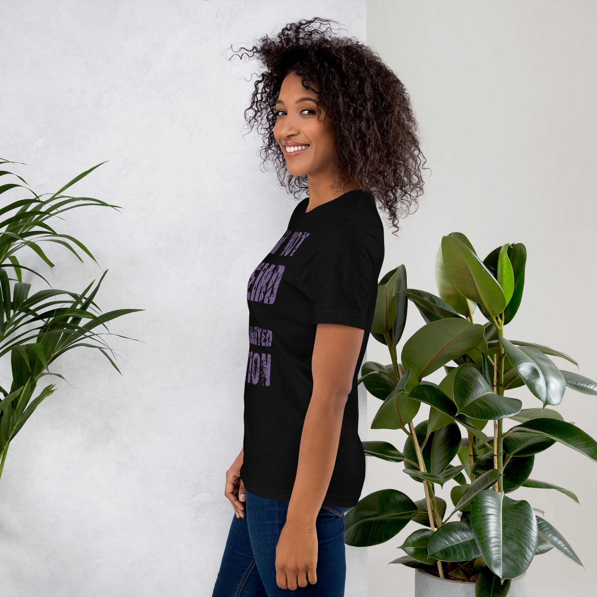 Unisex t-shirt with "I am not Weird" in purple text, worn by model, side view.