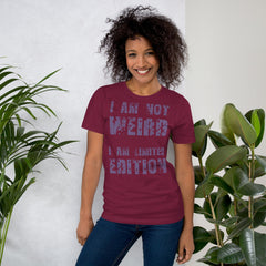 Unisex t-shirt with "I am not Weird" in purple text, worn by a smiling person.