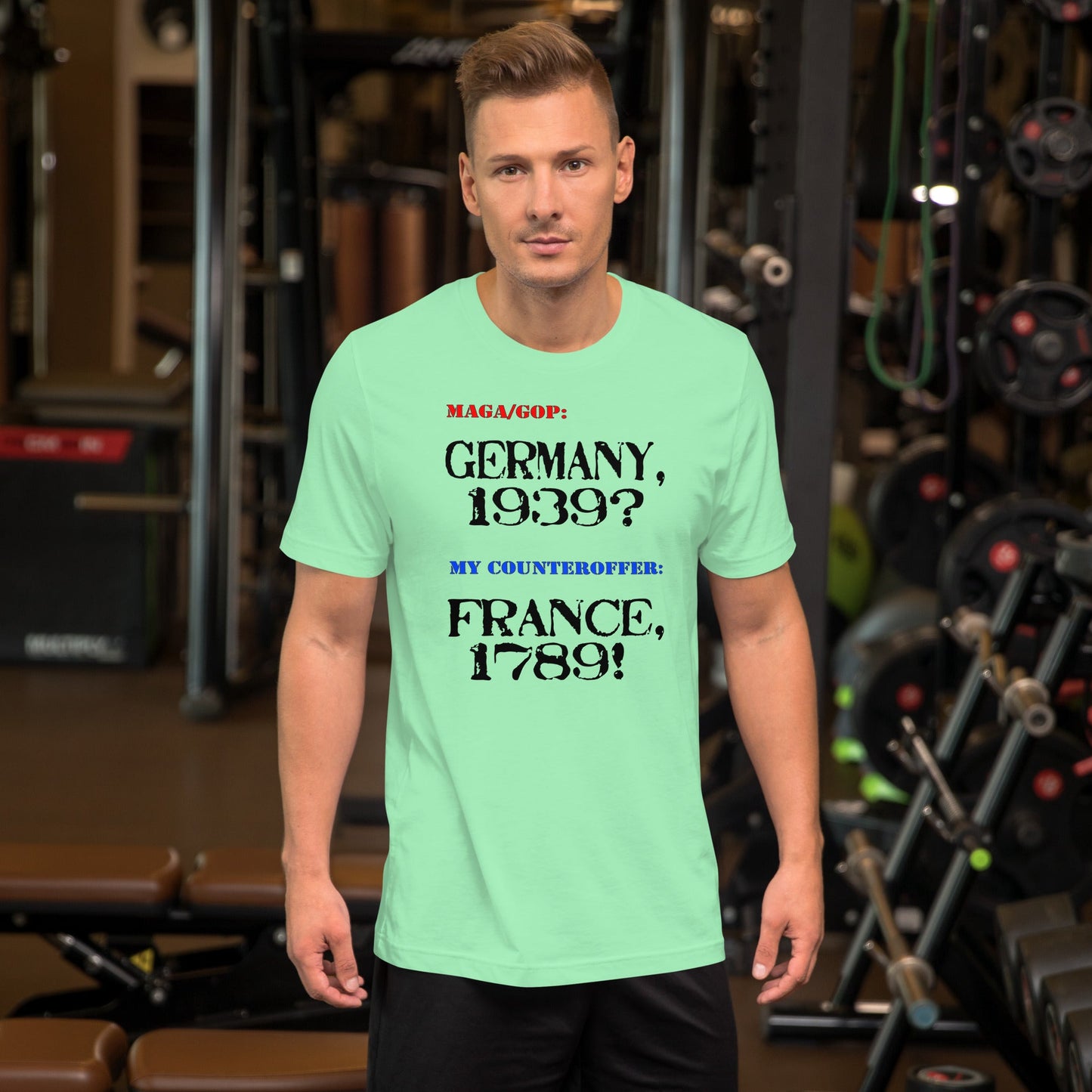 Unisex t-shirt with text "MAGA/GOP: Germany, 1939? My Counteroffer: France, 1789!" in a gym setting.