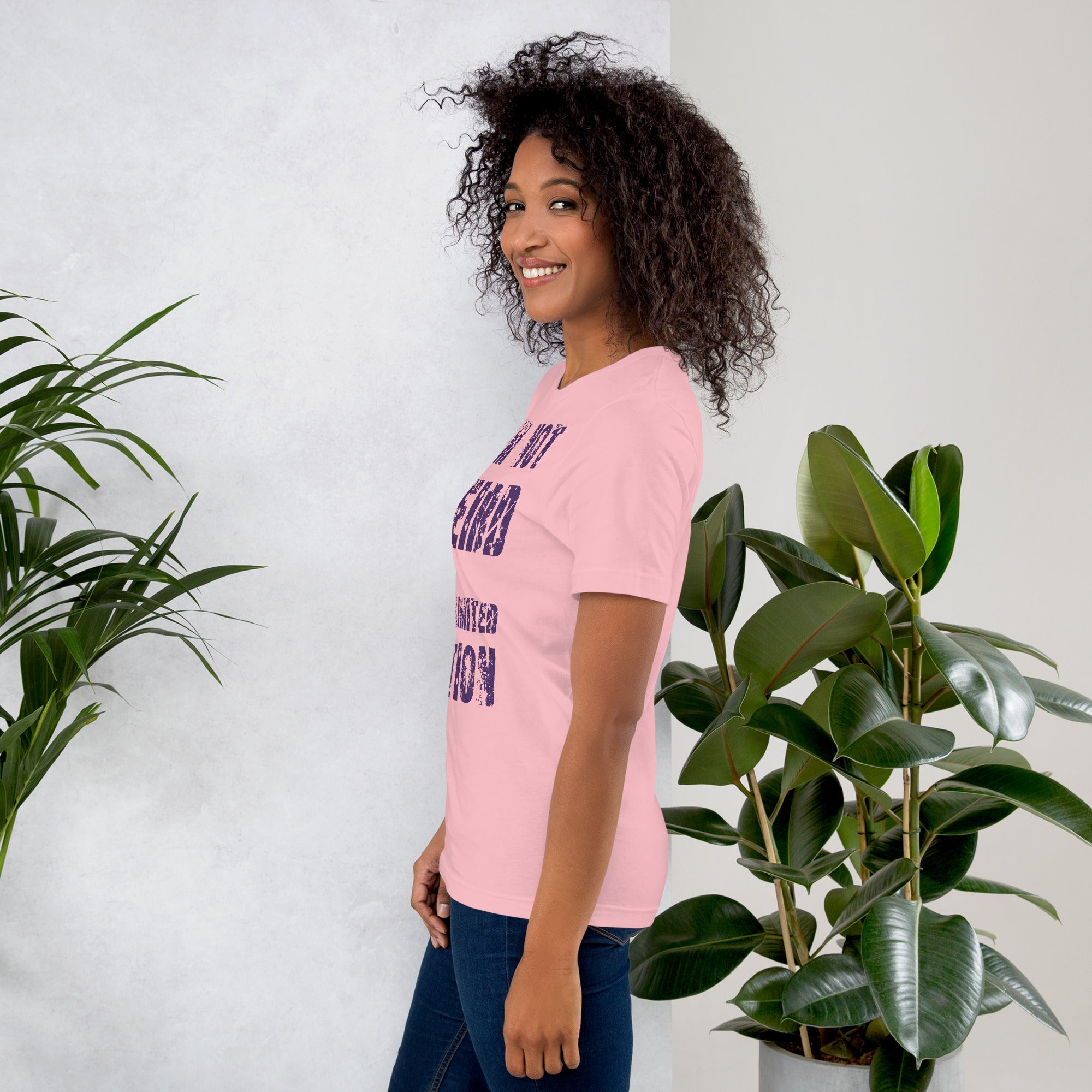 Unisex t-shirt with purple text "I am not Weird" on a person, soft pink fabric, casual fit.