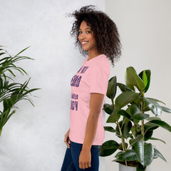 Unisex t-shirt with purple text "I am not Weird" on a person, soft pink fabric, casual fit.