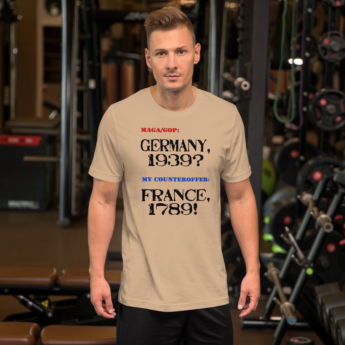 Unisex t-shirt with "Germany, 1939?" and "France, 1789!" text, soft and lightweight fabric, gym setting.