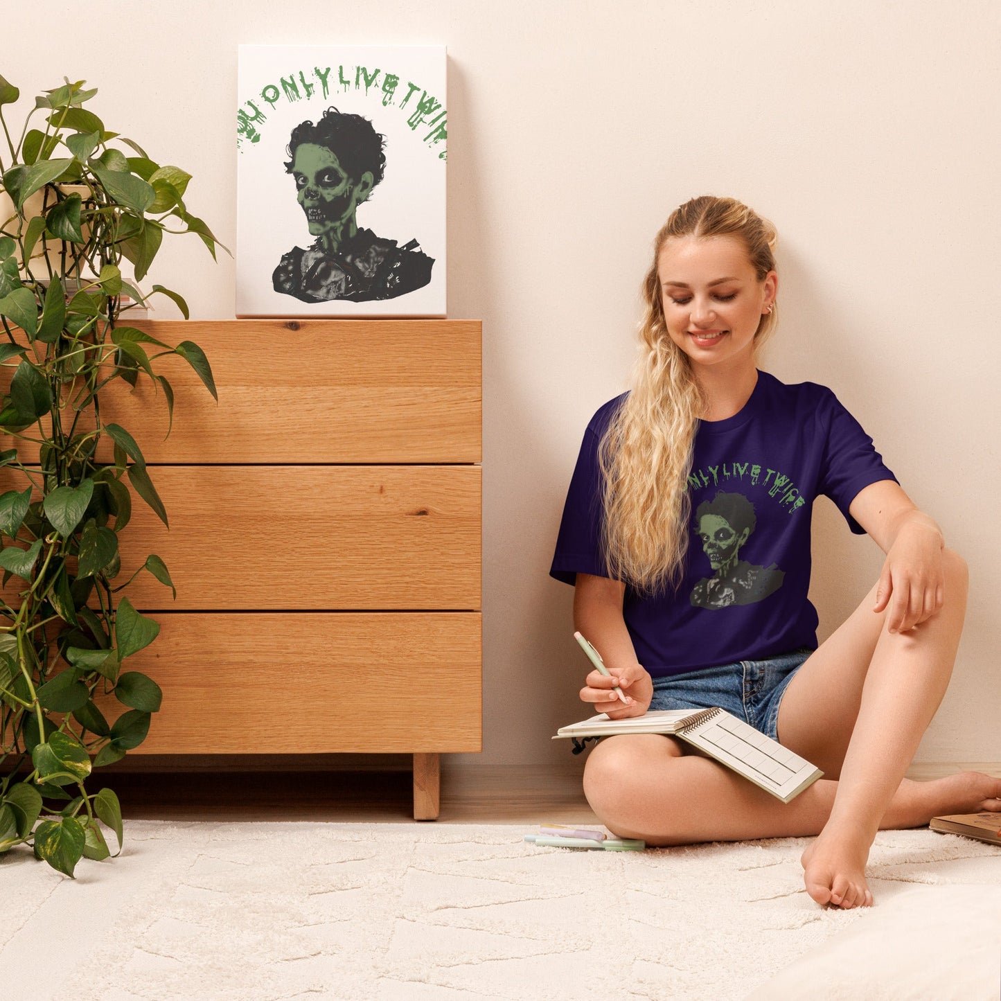 You only live twice vintage zombie unisex t-shirt worn by woman sitting on floor near drawer.