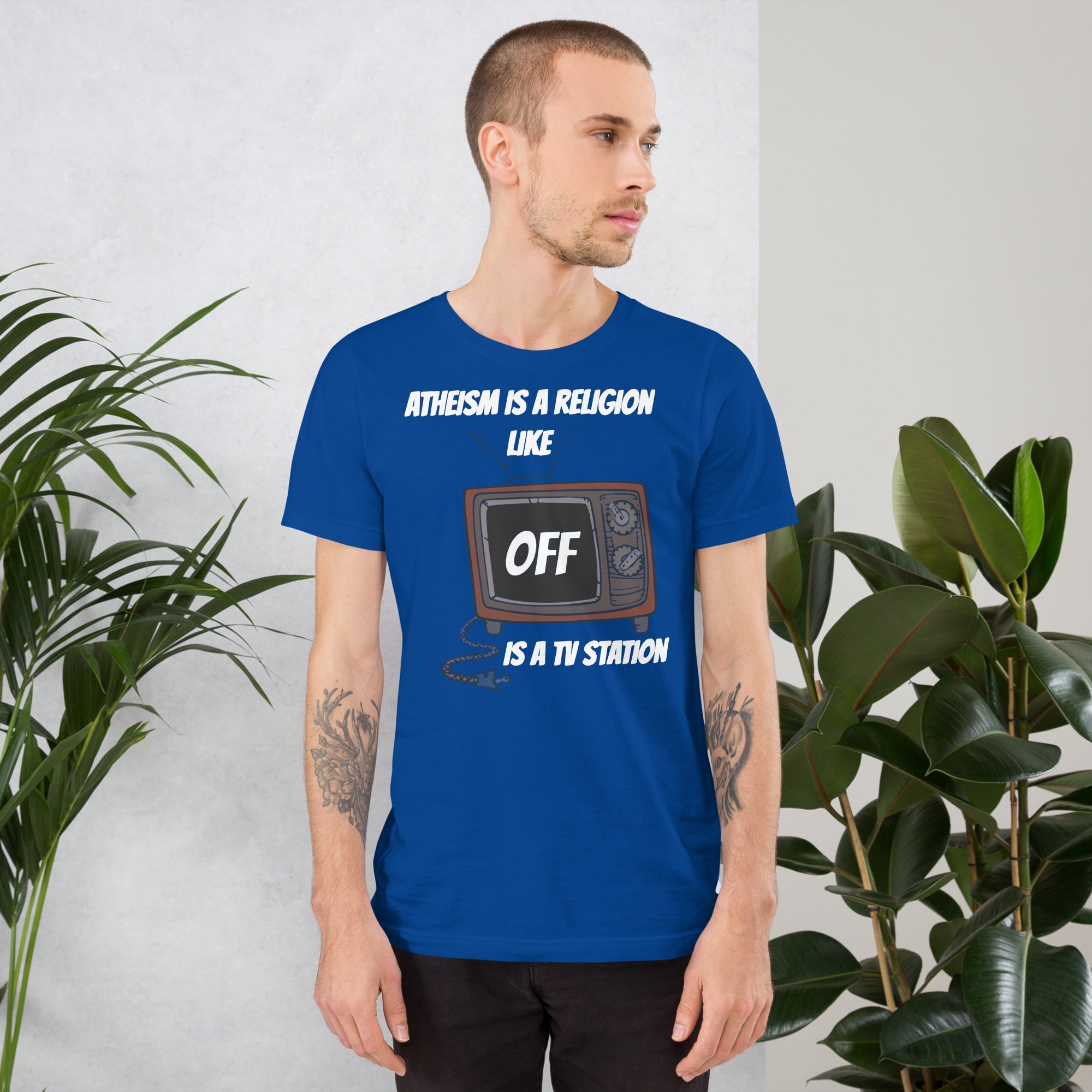 White unisex t-shirt with "Atheism is a religion like OFF is a TV station" design, featuring a vintage TV graphic.