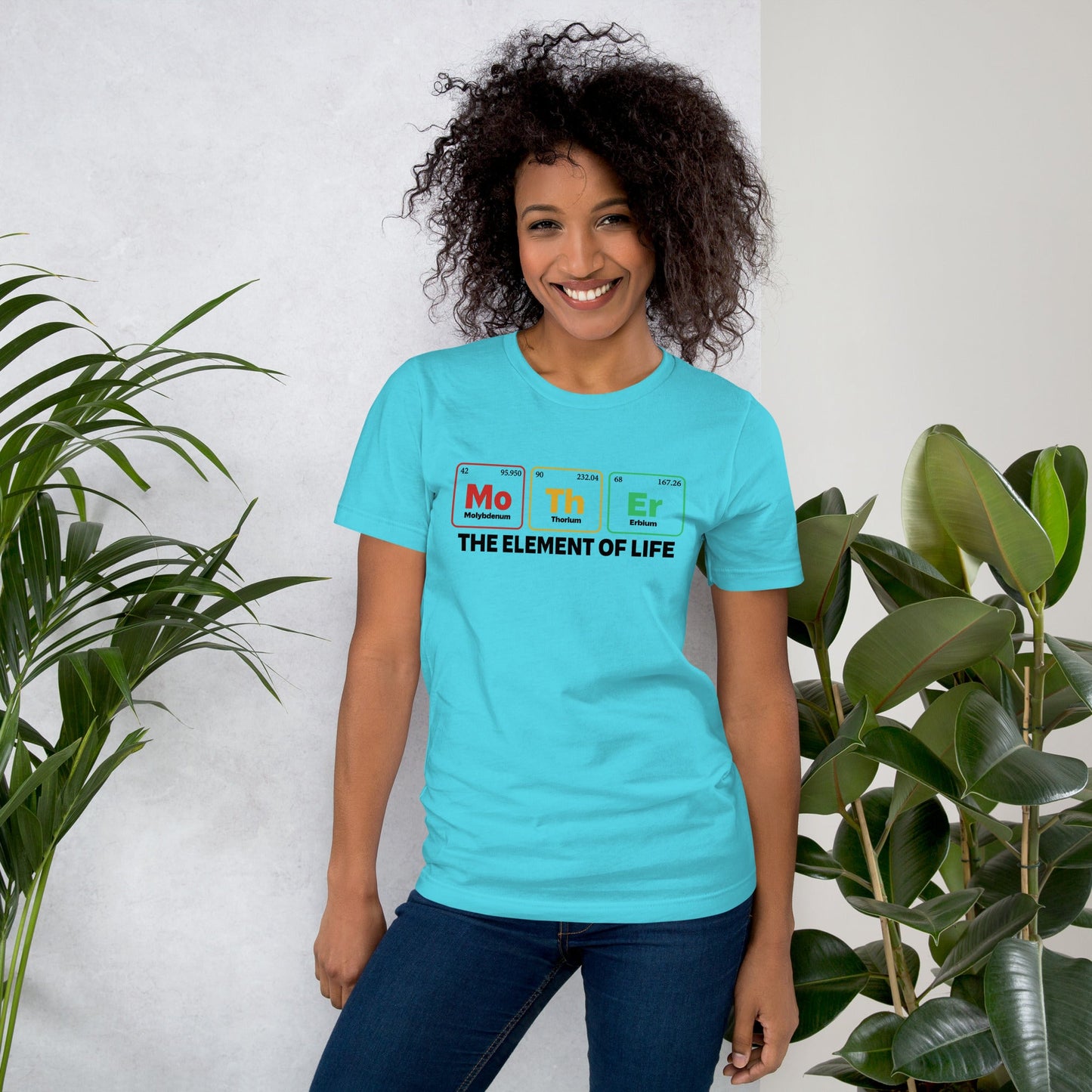 Light blue unisex t-shirt featuring "Mother - the Element of Life" design, worn by a model surrounded by plants.