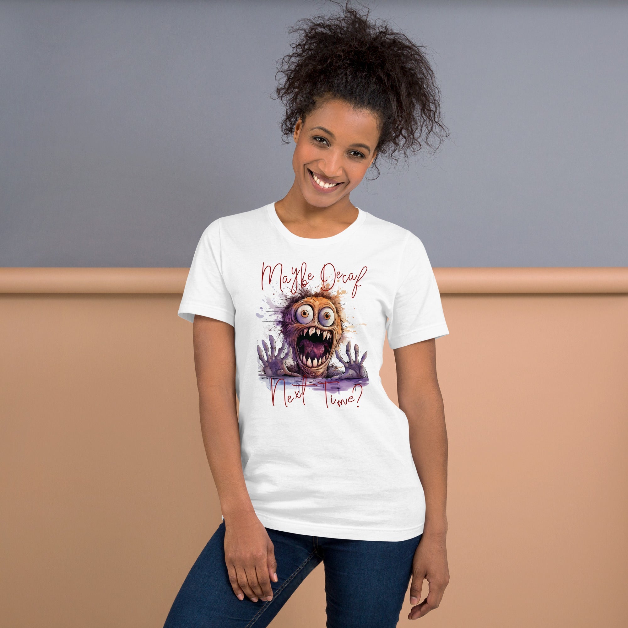 Unisex t-shirt with "Perhaps Decaf Next Time?" design, featuring a playful monster graphic on a soft white fabric.