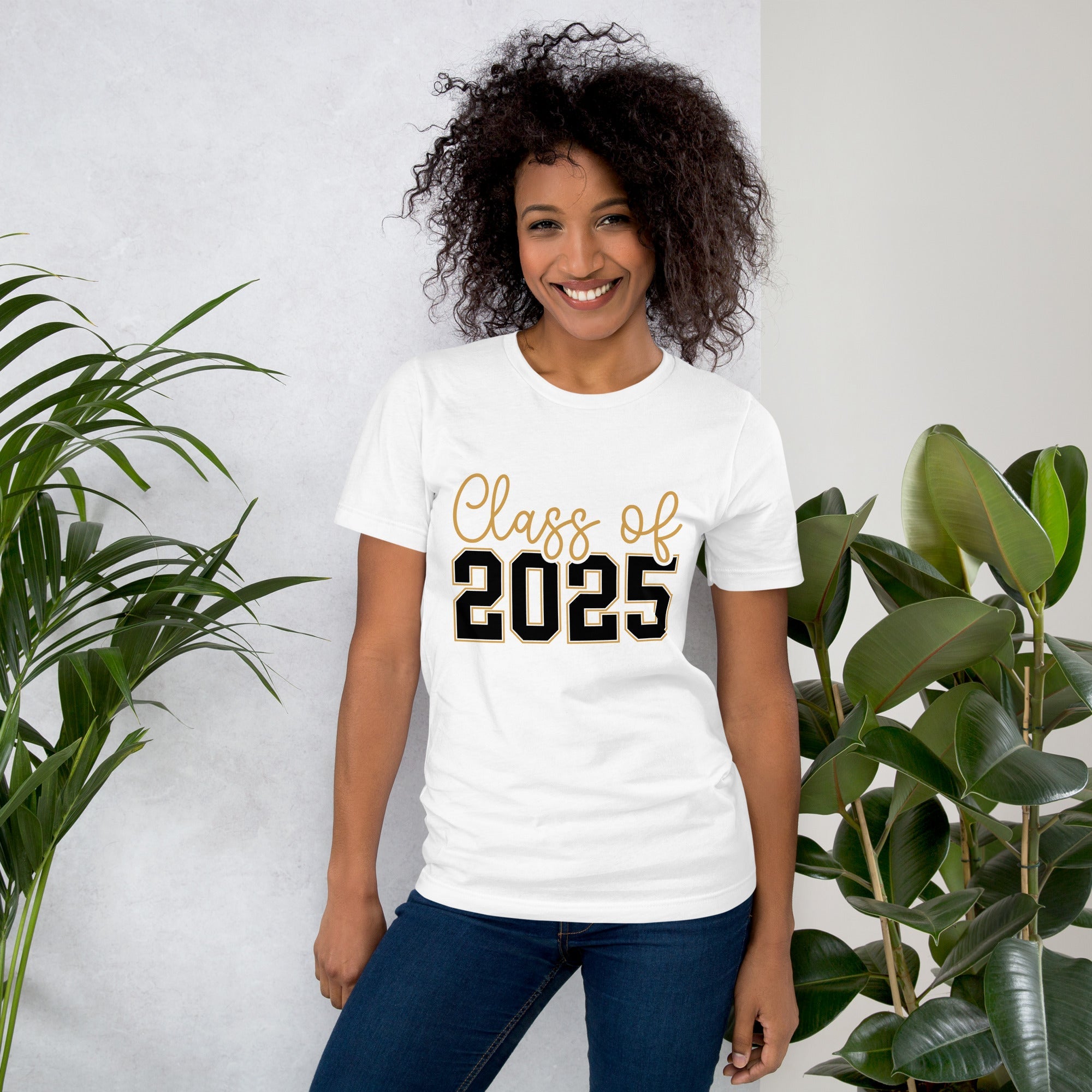 Class of 2025 unisex t-shirt, soft white cotton, worn by a smiling person, with plants in the background.