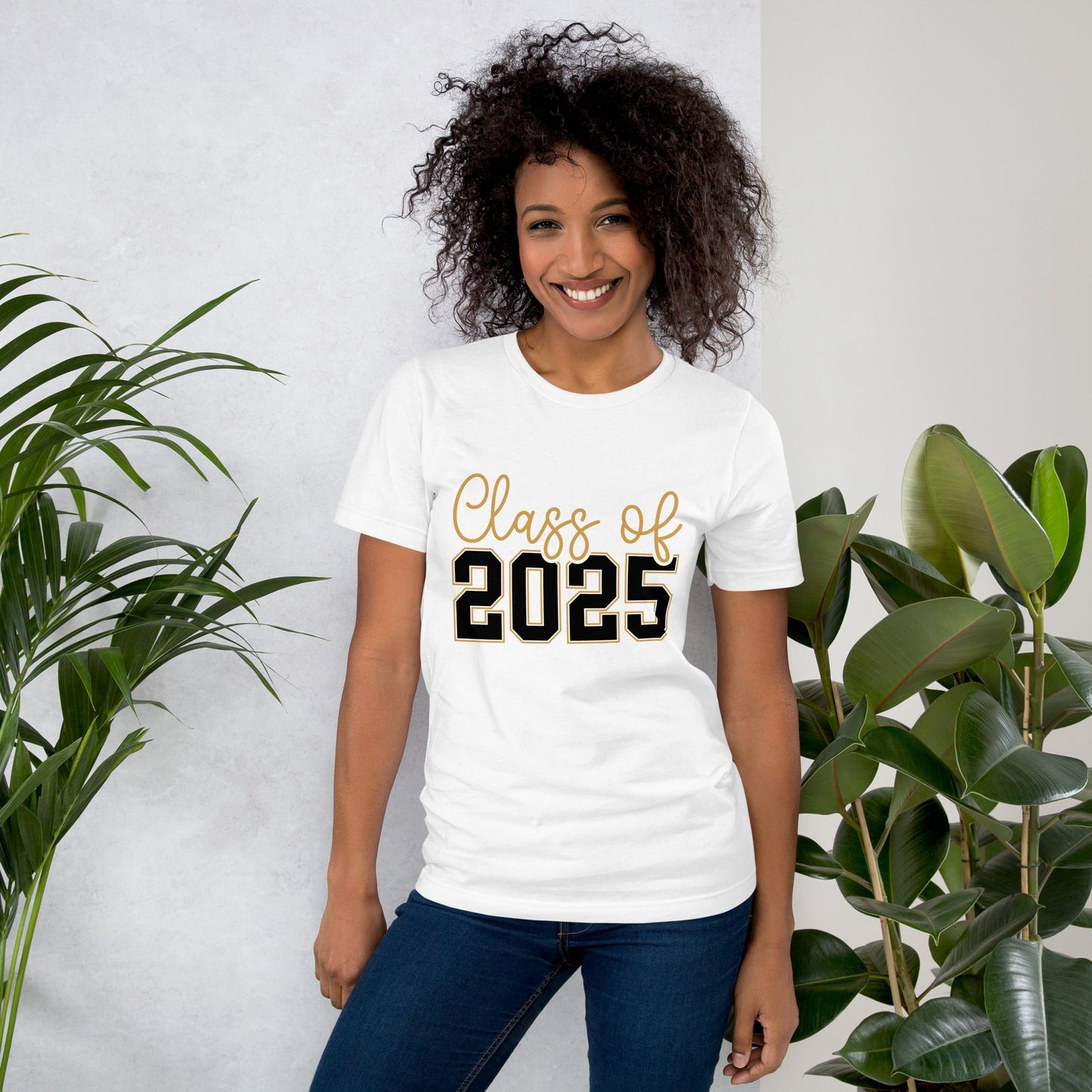 Class of 2025 unisex t-shirt, soft white cotton, worn by a smiling person, with plants in the background.