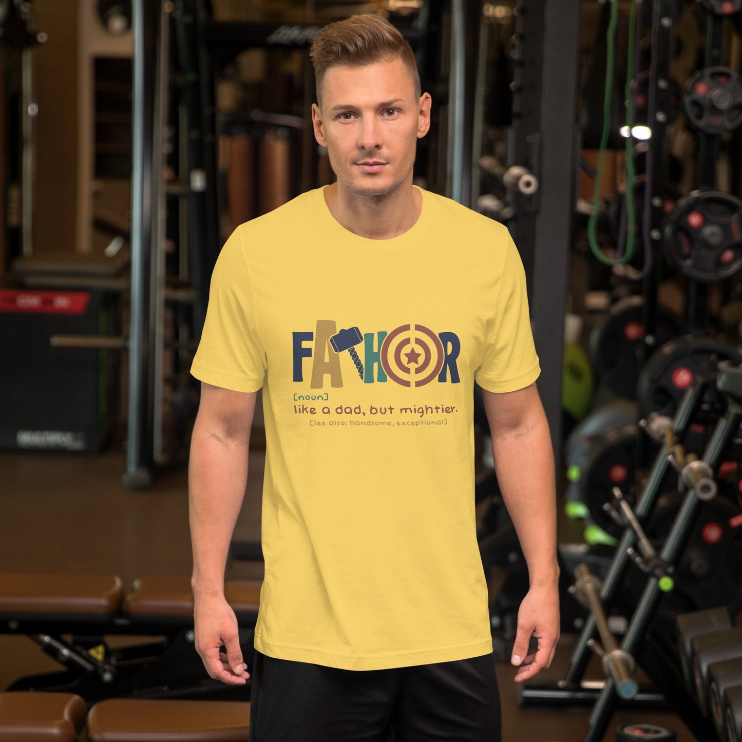 Yellow unisex t-shirt with "Fathor: Like a dad, but mightier" design, gym setting.