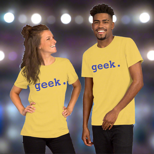 Unisex "geek." t-shirt, yellow with blue text, worn by a smiling man and woman against a blurred background.