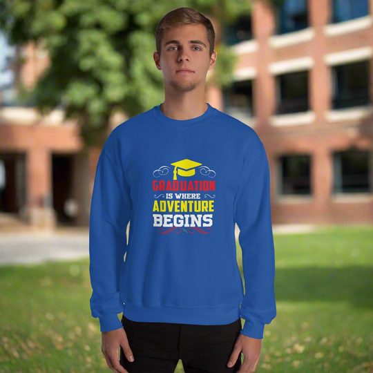 Unisex sweatshirt with "Graduation is where adventure begins" design, worn by a person outdoors.