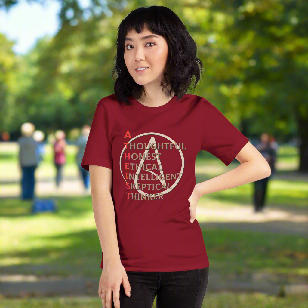 Unisex t-shirt with atheist spelled design and values words, worn outdoors.