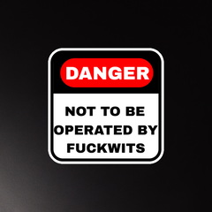 Danger sign with humorous text on a black background