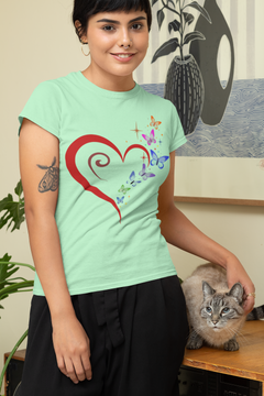 Women's relaxed t-shirt with heart, butterflies, stars design, worn by a woman standing next to a cat.