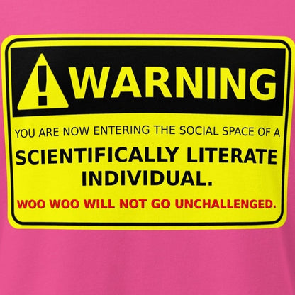 Close-up of a pink T-shirt with a bold yellow and black warning sign reading "Scientifically Literate Individual."