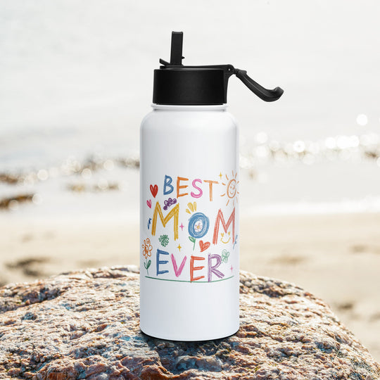 Stainless steel water bottle with "Best Mom Ever" design on a beach rock.
