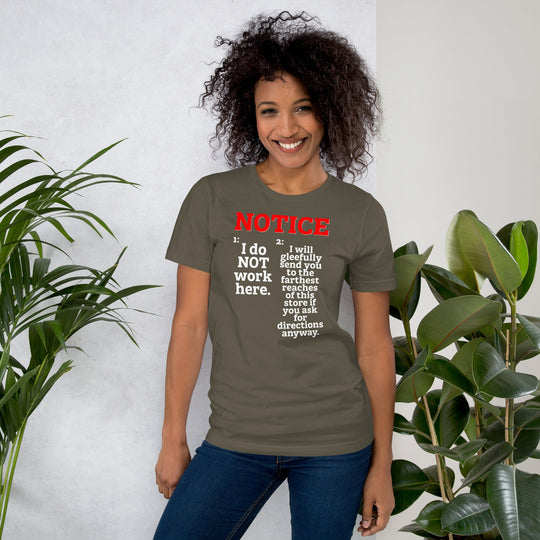 Unisex t-shirt with "NOTICE: I do NOT work here" text design, worn by a person standing indoors with plants in the background.