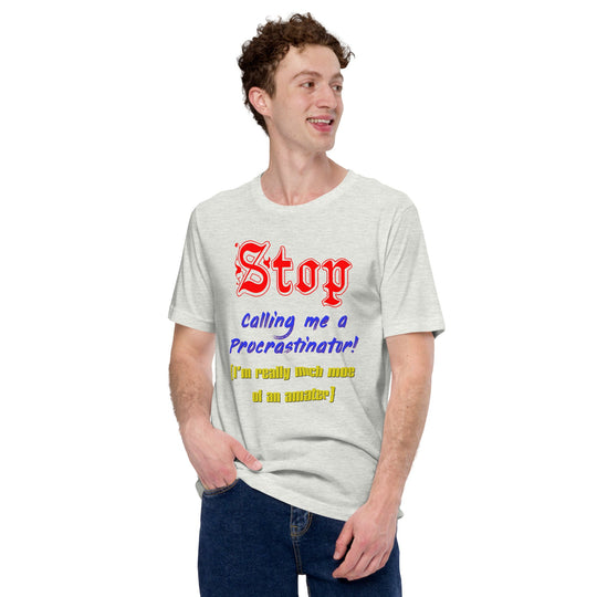 Unisex t-shirt with bold text "Stop calling me a procrastinator; I'm really much more of an amateur" in playful font, promoting humor and comfort.