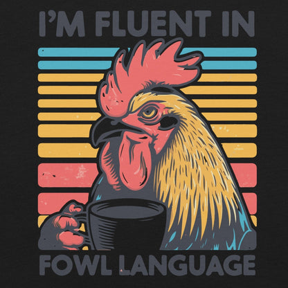 Quirky rooster sipping coffee on vibrant unisex t-shirt with "I'm Fluent in Fowl Language" text.