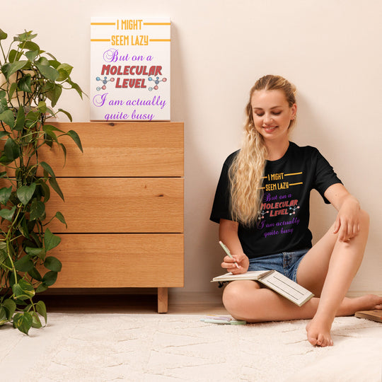 Unisex t-shirt with a humorous text design, worn by a person sitting comfortably on the floor, next to a wooden dresser and a plant.