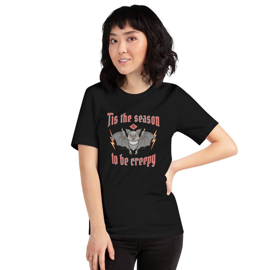 Unisex t-shirt with 'Tis the season to be creepy' Halloween design, worn by a person.