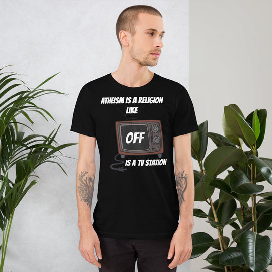 White unisex t-shirt with "Atheism is a religion like OFF is a TV station" graphic.