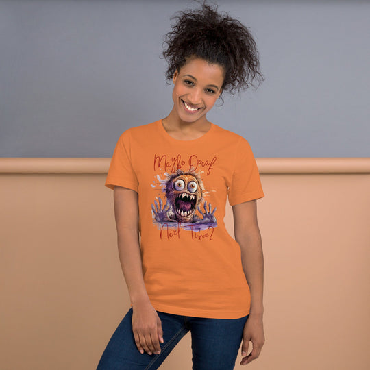 Unisex t-shirt with "Perhaps Decaf Next Time?" design, featuring a colorful cartoon monster graphic, worn by a smiling model.