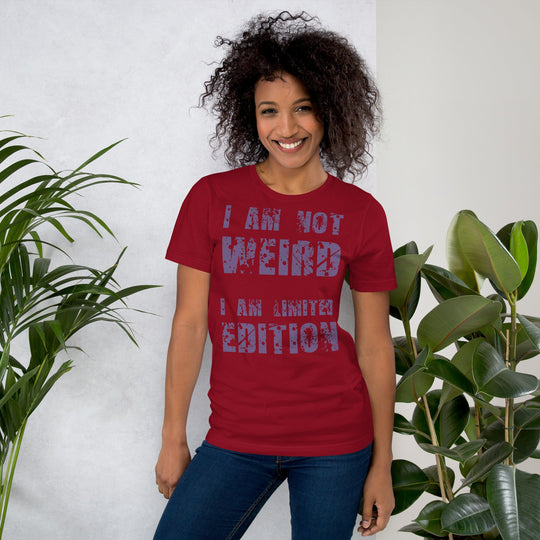 Unisex t-shirt with "I am not Weird" in purple text, worn by a person smiling.
