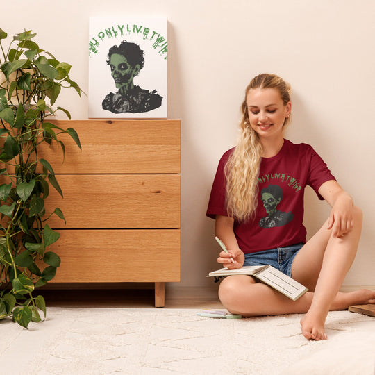 Unisex vintage zombie t-shirt with "You only live twice" design worn by smiling woman sitting on floor.