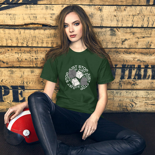 Unisex green t-shirt with "Just Stop" key caps design, worn by a person sitting on a wooden background.