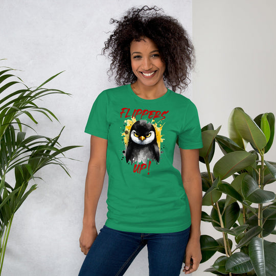 Unisex t-shirt with vibrant "Flippers Up" design, featuring a playful penguin graphic on a soft green fabric, surrounded by lush plants.