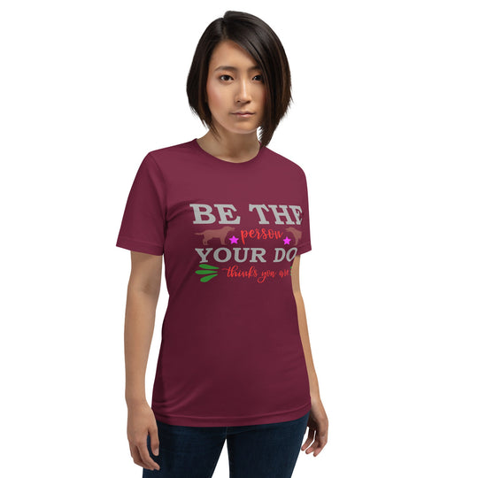 Unisex t-shirt with "Be the person your dog thinks you are" text, worn by model, soft cotton fabric.
