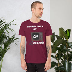 White unisex t-shirt with "Atheism is a religion like OFF is a TV station" design.