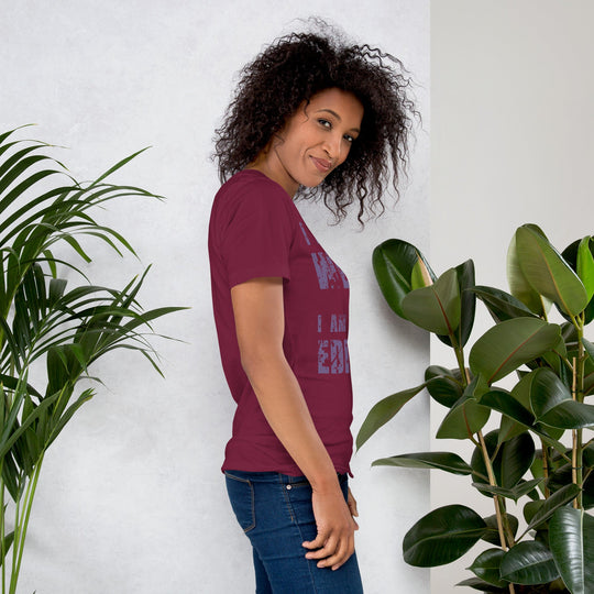Unisex t-shirt with "I am not Weird" in purple text, worn by a smiling person standing near plants.