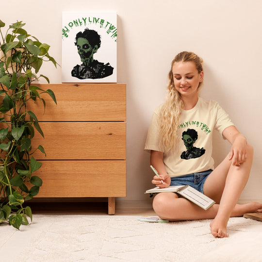 Vintage zombie t-shirt with "You Only Live Twice" design worn by a seated woman, next to a matching artwork on a wooden dresser.