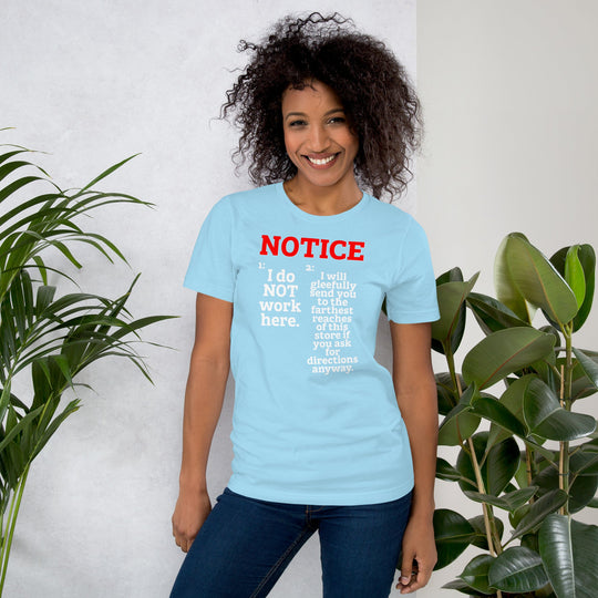 Unisex T-shirt with "NOTICE: I do NOT work here" print in red and white, worn by a smiling person.