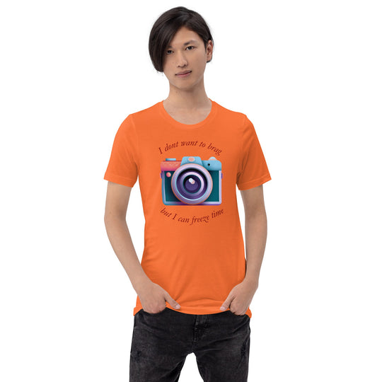 Unisex t-shirt with camera graphic and text "I don't want to brag, but I can freeze time" in vibrant orange.