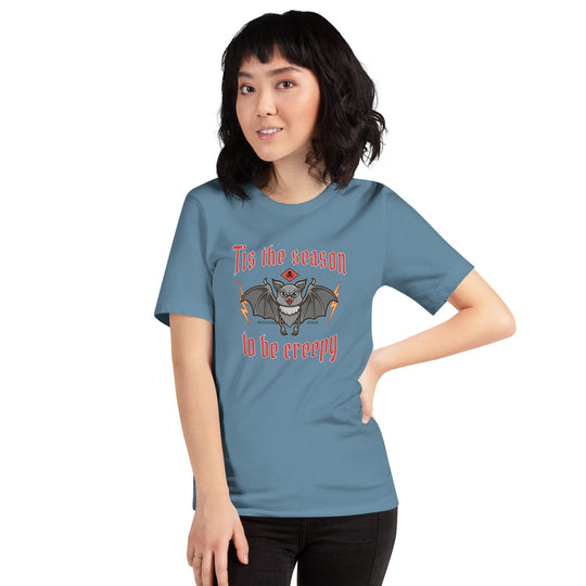 Unisex t-shirt with "Tis the season to be creepy" design, featuring a bat illustration, perfect for Halloween.