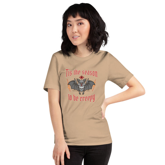 Unisex t-shirt with Halloween theme design, featuring "Tis the season to be creepy" text and a bat illustration.