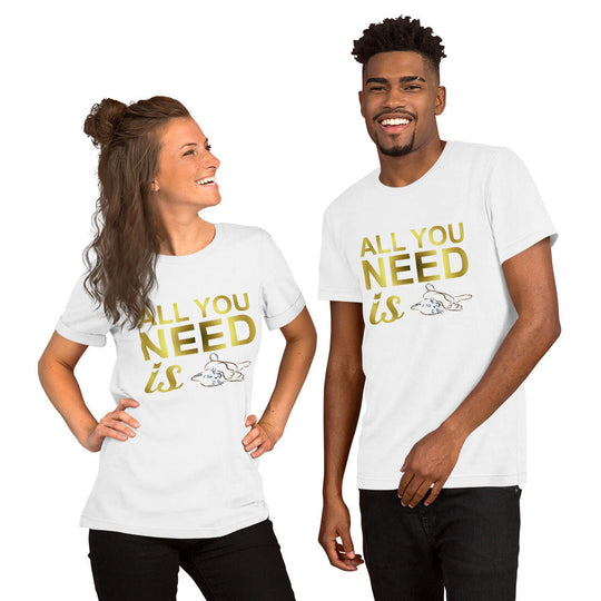 Unisex t-shirt with "All you need is" design, featuring cat illustration, worn by smiling man and woman.