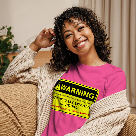 Woman wearing "Warning! Scientifically Literate Individual" pink relaxed t-shirt, smiling.