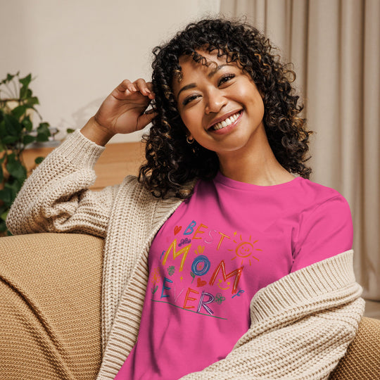 Woman smiling in a "Best Mom Ever" pink women's relaxed t-shirt with a cozy cardigan.