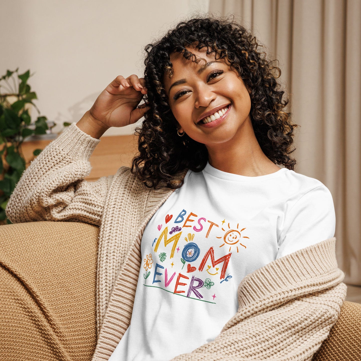Best Mom Ever women's relaxed t-shirt in white, worn by smiling person indoors.